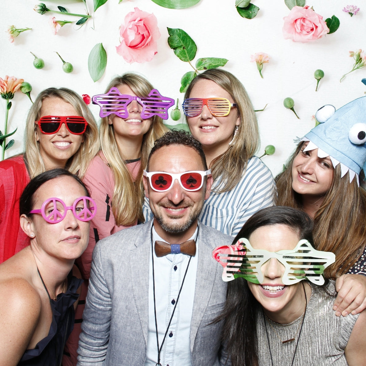 Coworkers from Urban Outfitters in Philadelphia posing in a photo booth with silly glasses