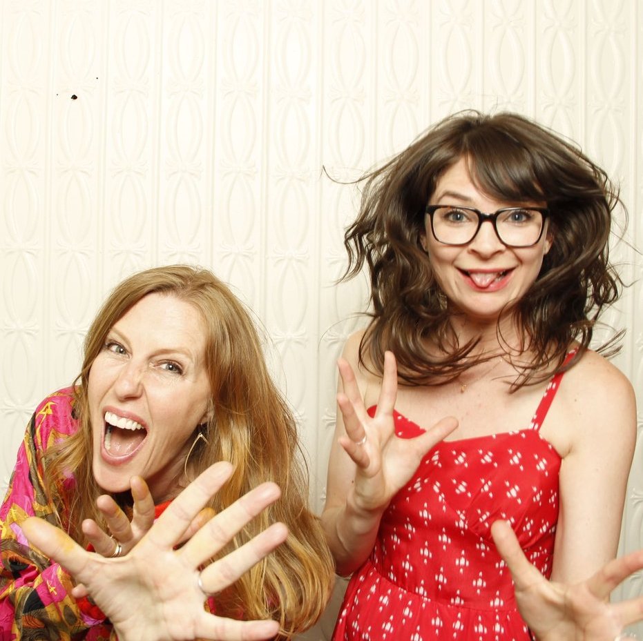 Two women having fun in a photo booth