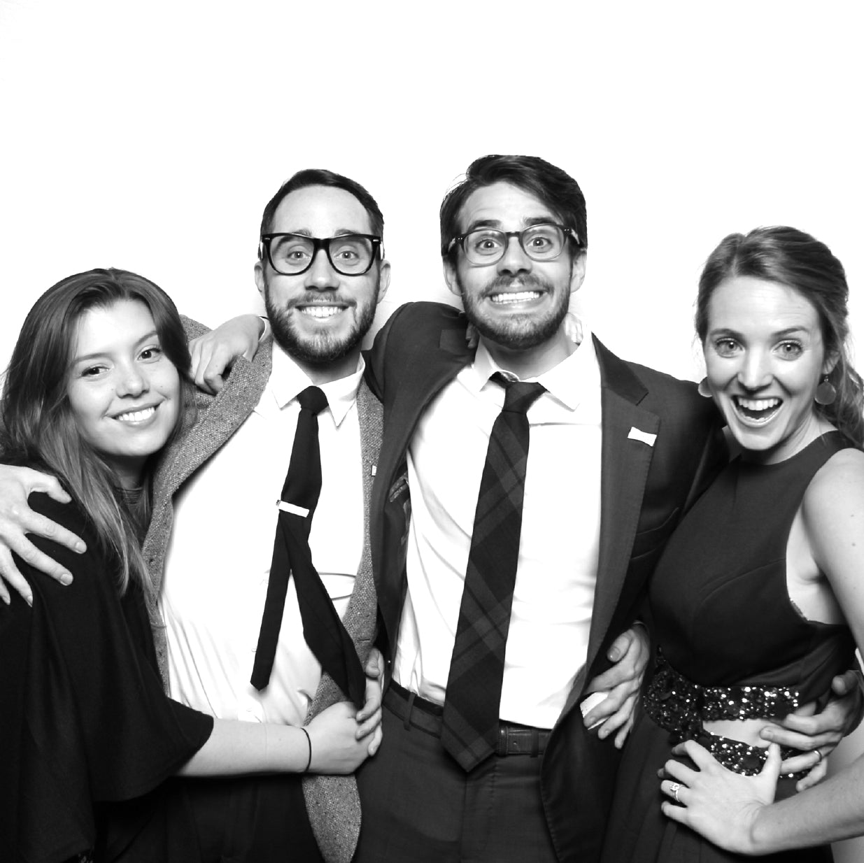 Group of friends posing in a photo booth with a black and white filter