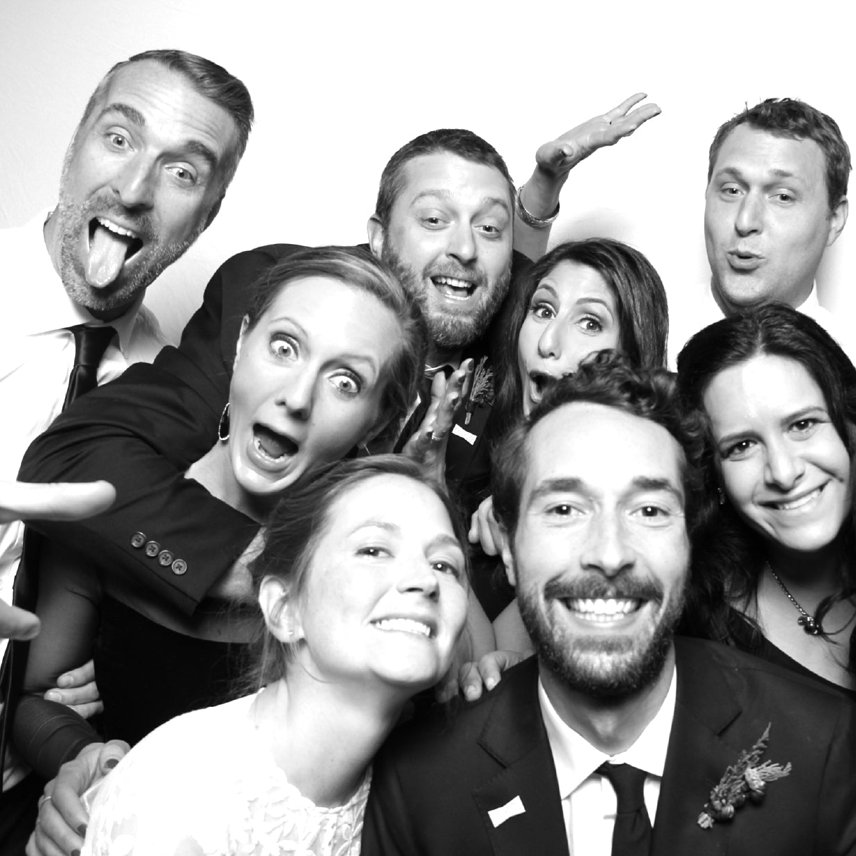 Large group of friends in a black and white wedding photo booth picture