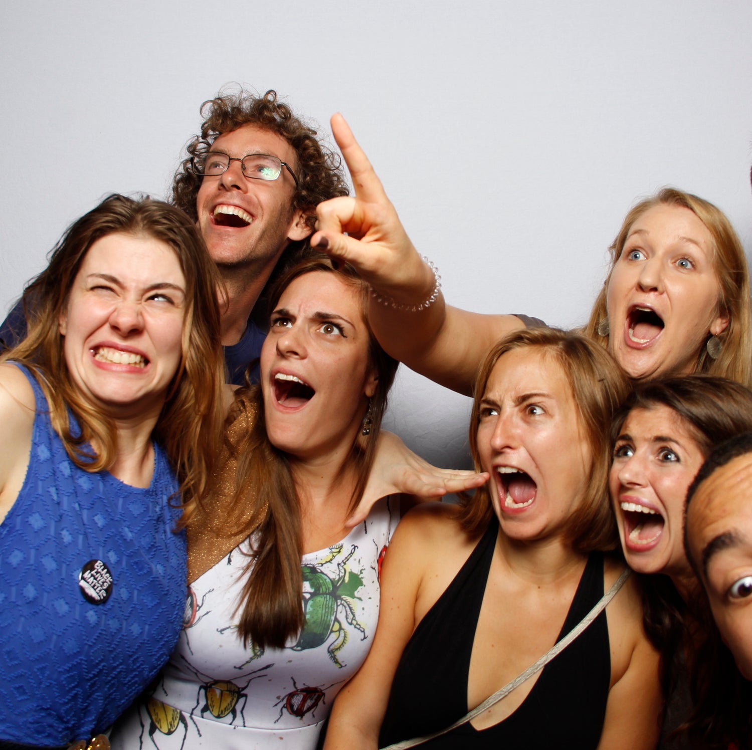 Group of friends in a photo booth picture looking off into the distance