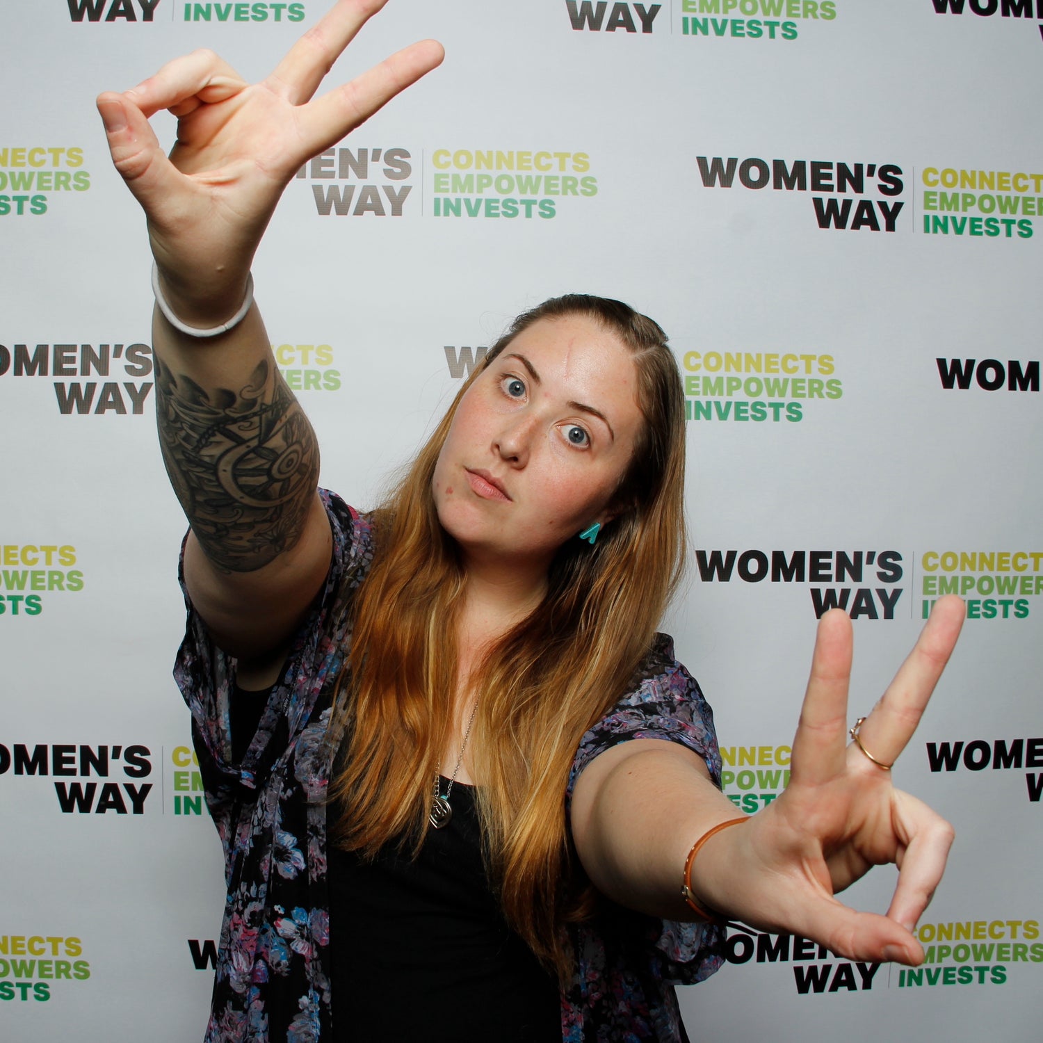 Woman giving peace signs in the Women's Way Philadelphia Event Photo Booth