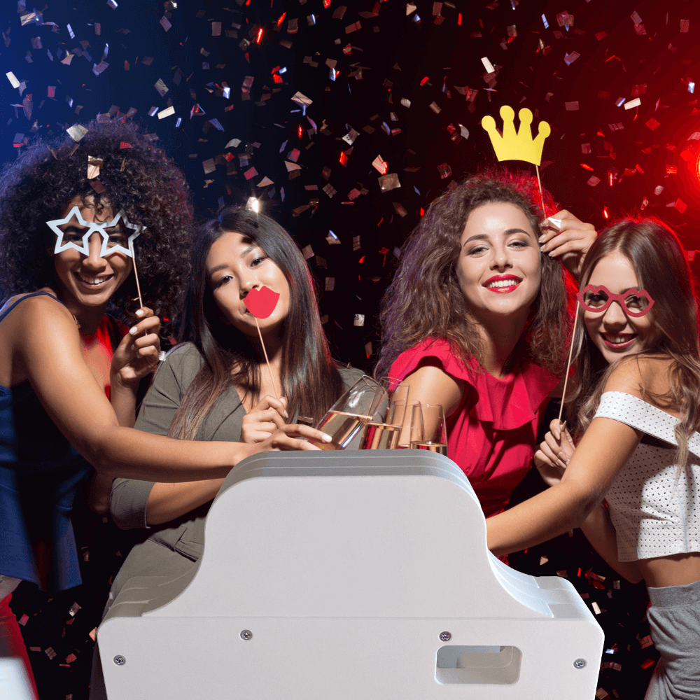 Women having a great time using a DIY photo booth kit with props