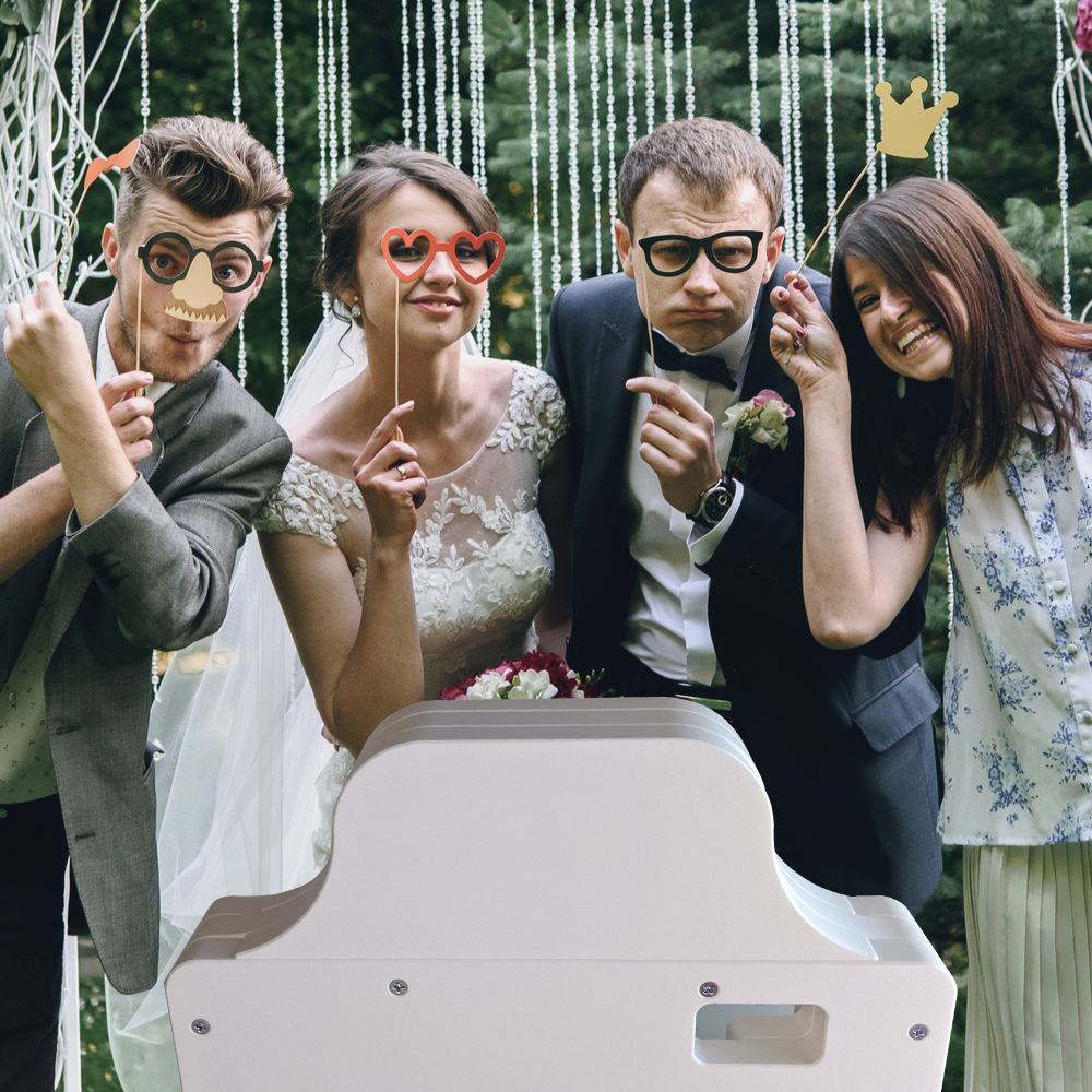Group of Friends Posing in an Open-Air Photo Booth at a Wedding