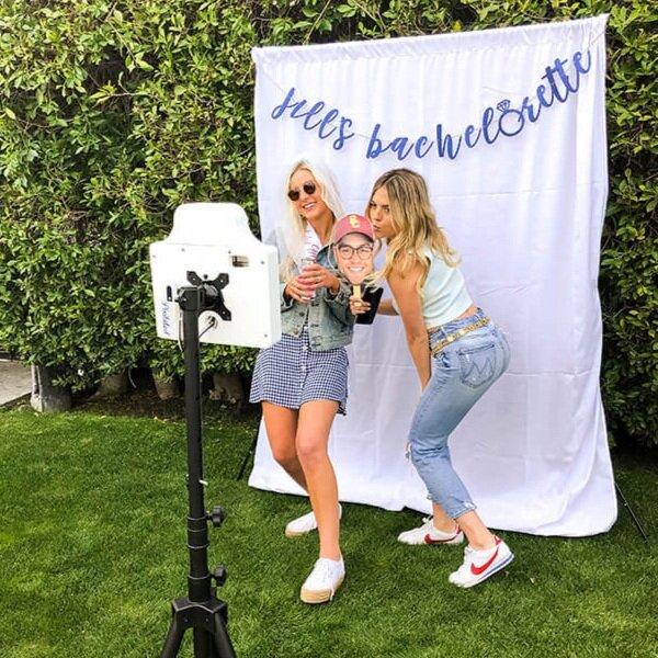 Women posing in a Pixilated open-air photo booth kiosk