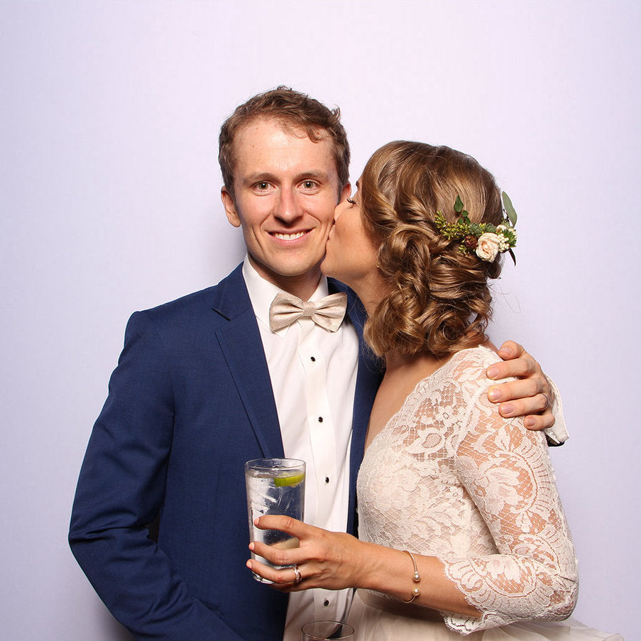 Couple kissing in a wedding photo booth