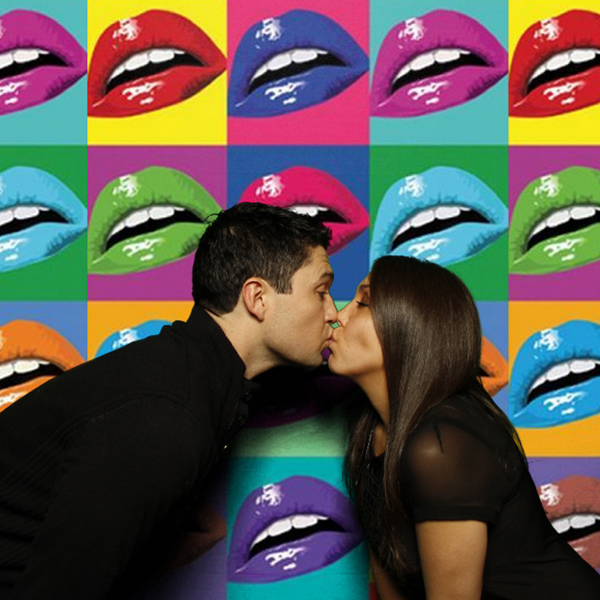 Couple kissing in a green screen photo booth with colorful pop-art background